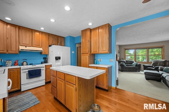 2401 W Dale Ct, Bettendorf, IA 52722 - kitchen featuring white appliances, under cabinet range hood, light countertops, a textured ceiling, and open floor plan