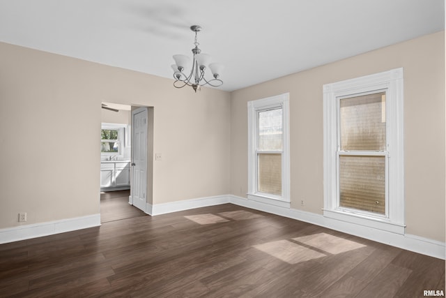 1114 E 15th St, Davenport, IA 52803 - unfurnished room featuring a chandelier and dark wood-style floors