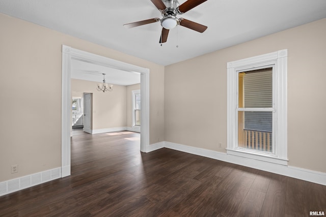 1114 E 15th St, Davenport, IA 52803 - empty room with a chandelier, dark wood-style floors, and a ceiling fan