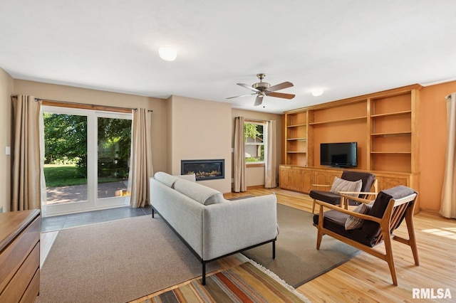 1928 Elm St, Davenport, IA 52803 - living room with plenty of natural light, ceiling fan, a glass covered fireplace, and built in features