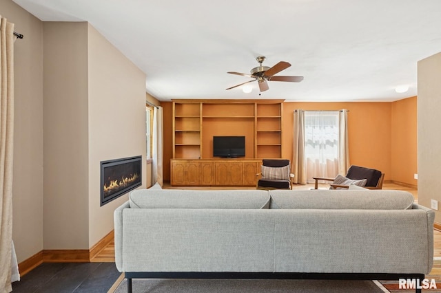 1928 Elm St, Davenport, IA 52803 - living room featuring healthy amount of natural light, a glass covered fireplace, ceiling fan, and built in shelves