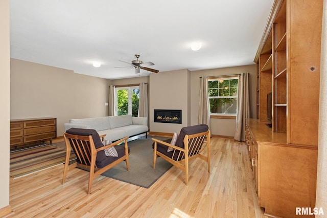 1928 Elm St, Davenport, IA 52803 - living area with light wood-style floors, ceiling fan, and a glass covered fireplace