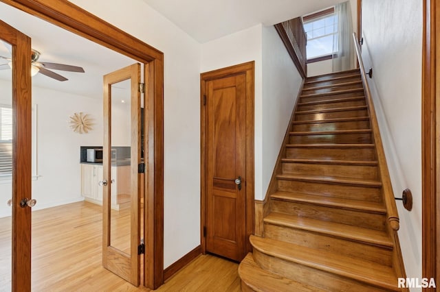 1928 Elm St, Davenport, IA 52803 - staircase with wood finished floors, french doors, and ceiling fan