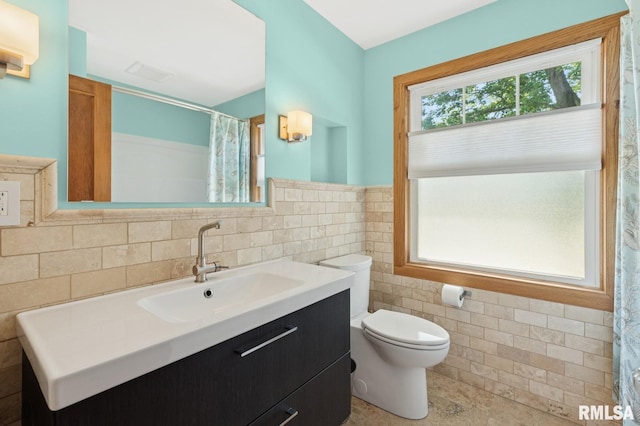 1928 Elm St, Davenport, IA 52803 - full bath with tile walls, vanity, wainscoting, and curtained shower