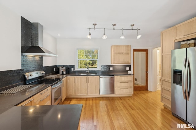 1928 Elm St, Davenport, IA 52803 - kitchen with appliances with stainless steel finishes, light brown cabinetry, and wall chimney exhaust hood