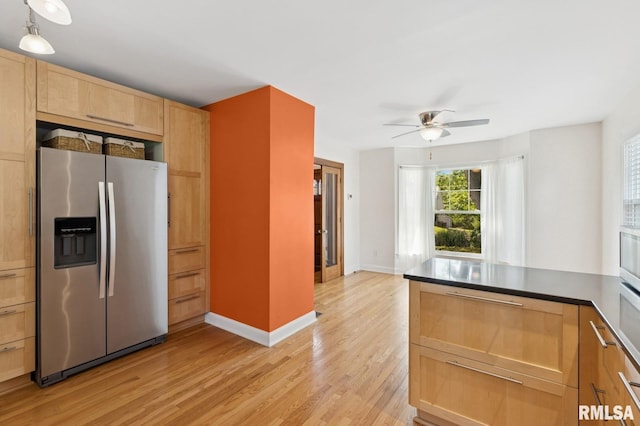 1928 Elm St, Davenport, IA 52803 - kitchen featuring stainless steel fridge with ice dispenser, light brown cabinets, light wood-style floors, a ceiling fan, and dark countertops