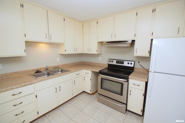 3618 18th St, Bettendorf, IA 52722 - kitchen with freestanding refrigerator, electric range, under cabinet range hood, light countertops, and light tile patterned floors