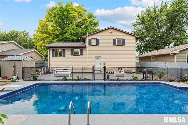1215 Calvin St, Davenport, IA 52804 - view of swimming pool featuring a storage unit, a fenced backyard, a gate, and a patio