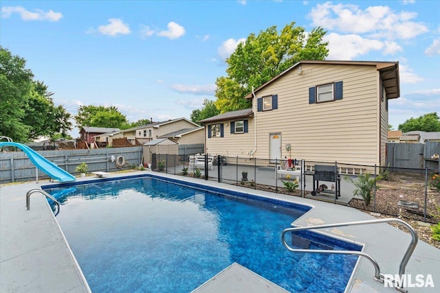 1215 Calvin St, Davenport, IA 52804 - view of swimming pool featuring a water slide and a fenced backyard