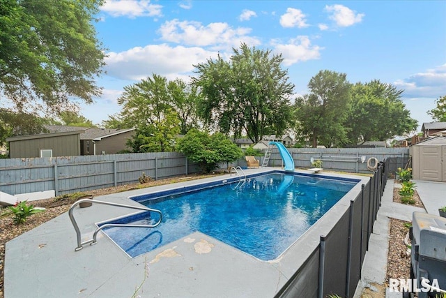 1215 Calvin St, Davenport, IA 52804 - view of pool with a water slide, a storage shed, a fenced backyard, and a patio area
