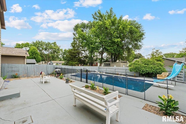 1215 Calvin St, Davenport, IA 52804 - view of pool featuring a water slide, a patio, and a fenced backyard