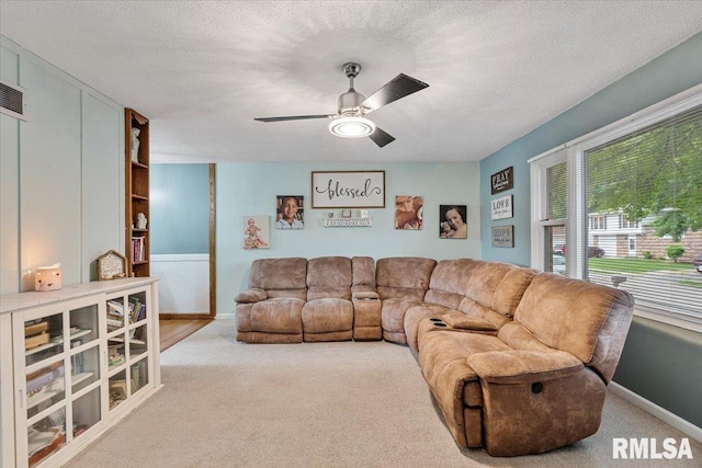 1215 Calvin St, Davenport, IA 52804 - living area featuring carpet floors, ceiling fan, and a textured ceiling