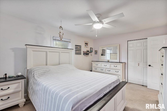 1215 Calvin St, Davenport, IA 52804 - bedroom with light carpet, a ceiling fan, and a closet