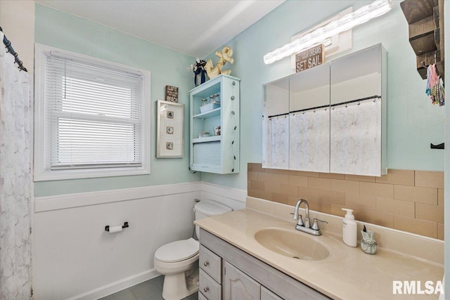 1215 Calvin St, Davenport, IA 52804 - full bath featuring vanity, backsplash, tile patterned floors, a shower with shower curtain, and a wainscoted wall