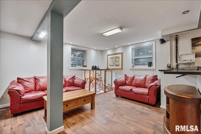 1215 Calvin St, Davenport, IA 52804 - living room featuring wood finished floors and a textured ceiling