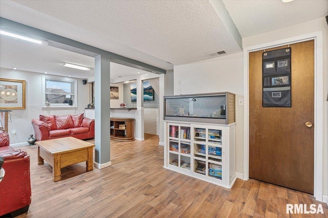 1215 Calvin St, Davenport, IA 52804 - living room featuring wood finished floors and a textured ceiling