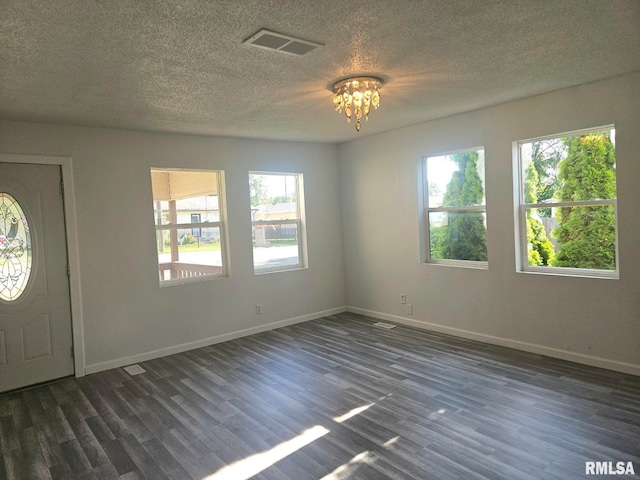 1912 Breese St, Muscatine, IA 52761 - entrance foyer featuring dark wood-style flooring, a chandelier, and a textured ceiling