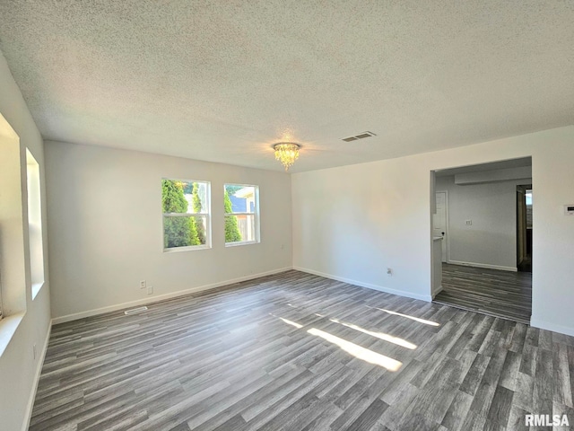 1912 Breese St, Muscatine, IA 52761 - spare room featuring wood finished floors and a textured ceiling