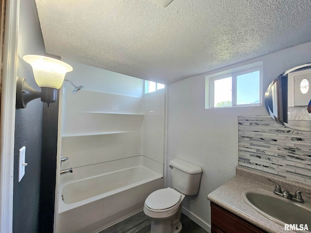 1912 Breese St, Muscatine, IA 52761 - full bathroom featuring a textured ceiling, vanity, shower / bath combination, and wood finished floors