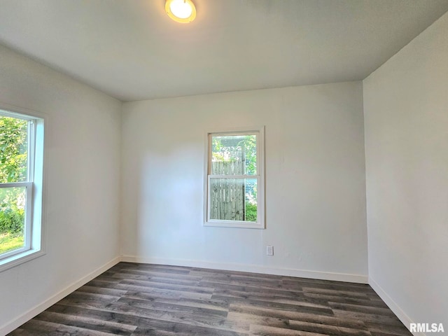 1912 Breese St, Muscatine, IA 52761 - empty room featuring healthy amount of natural light and dark wood finished floors