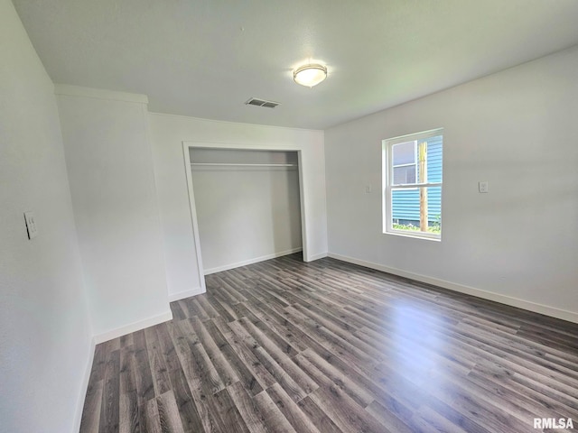 1912 Breese St, Muscatine, IA 52761 - unfurnished bedroom featuring dark wood-style floors and a closet