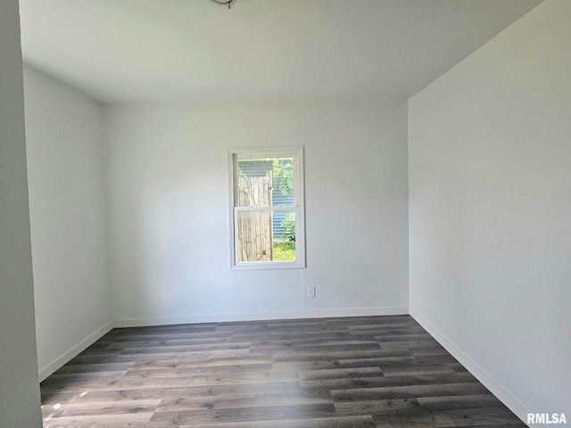 1912 Breese St, Muscatine, IA 52761 - spare room with dark wood-type flooring and baseboards