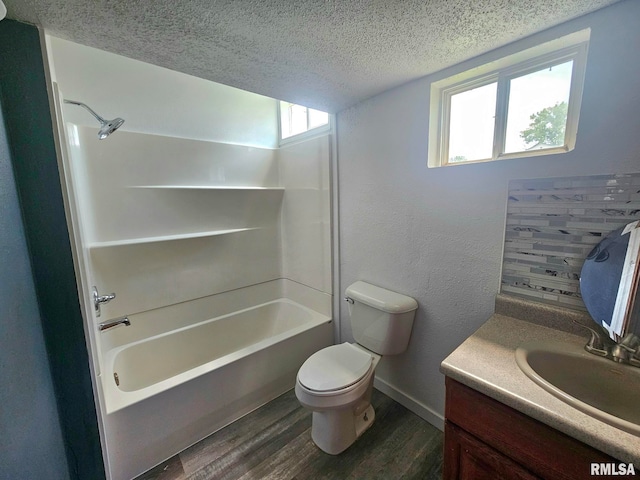1912 Breese St, Muscatine, IA 52761 - bathroom with wood finished floors, a textured ceiling, vanity, and shower / bathtub combination