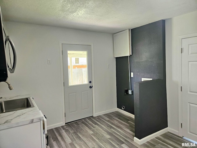 1912 Breese St, Muscatine, IA 52761 - laundry room with light wood finished floors and a textured ceiling