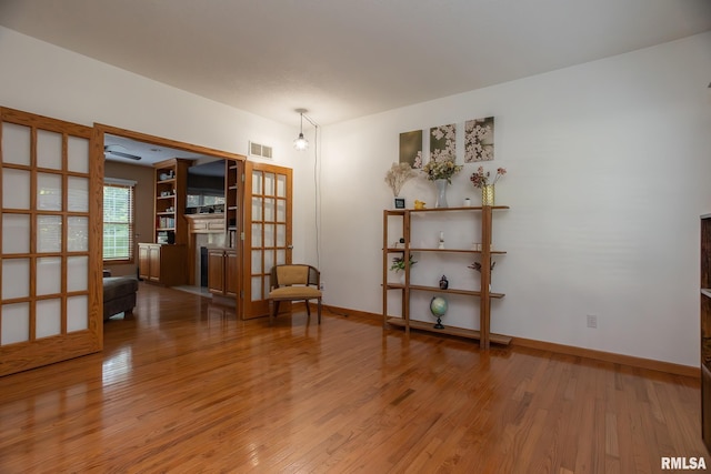 1199 Scenic Place, Le Claire, IA 52753 - sitting room featuring a fireplace and wood finished floors