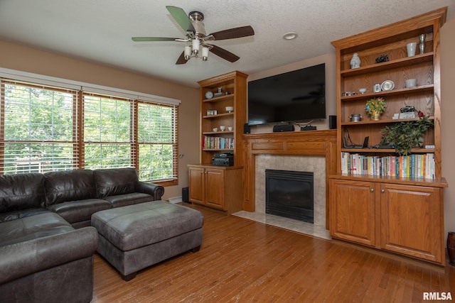 1199 Scenic Place, Le Claire, IA 52753 - living area with a fireplace, light wood-style floors, and ceiling fan