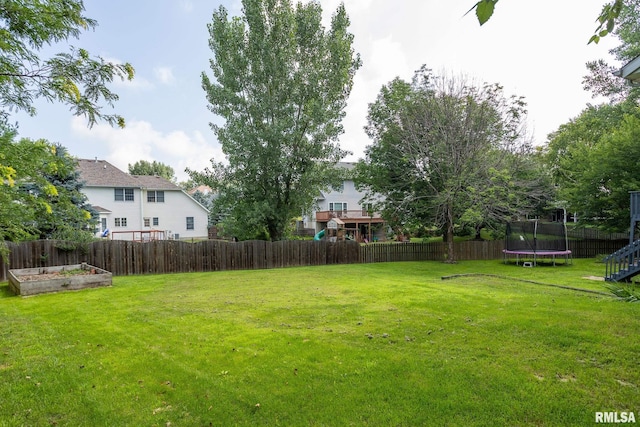 1199 Scenic Place, Le Claire, IA 52753 - fenced backyard with a trampoline and a garden