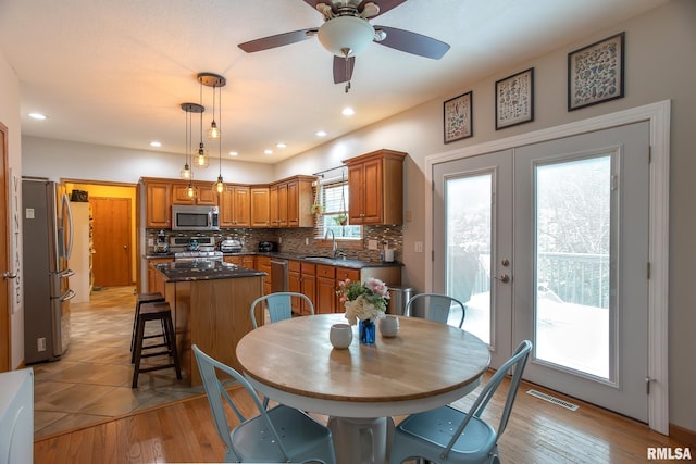 1199 Scenic Place, Le Claire, IA 52753 - dining room featuring a ceiling fan, recessed lighting, and light wood-style flooring