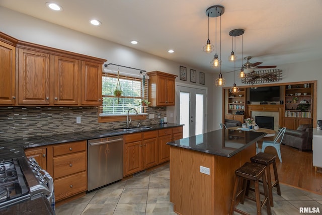 1199 Scenic Place, Le Claire, IA 52753 - kitchen with dishwasher, open floor plan, range, a kitchen breakfast bar, and decorative backsplash