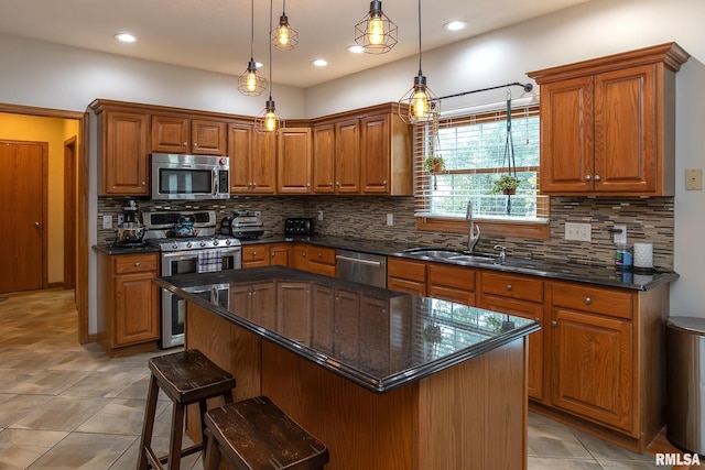 1199 Scenic Place, Le Claire, IA 52753 - kitchen featuring stainless steel appliances, tasteful backsplash, brown cabinets, dark stone counters, and recessed lighting
