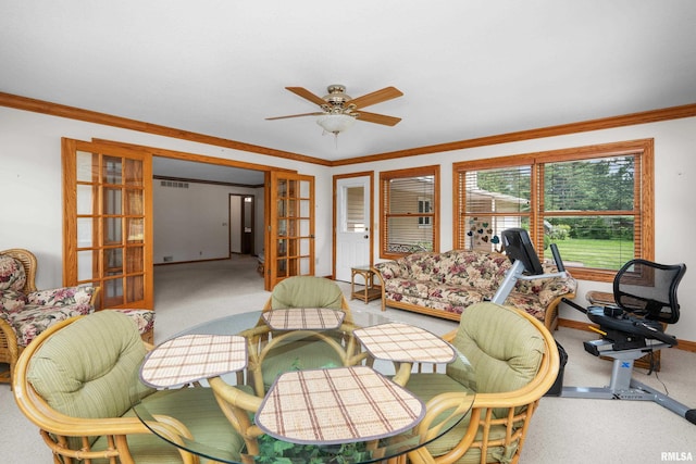 2303 Wynnewood Ct, Davenport, IA 52807 - living area featuring french doors, carpet flooring, a ceiling fan, and crown molding