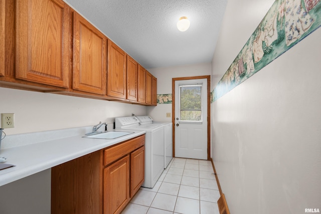 2303 Wynnewood Ct, Davenport, IA 52807 - laundry room with independent washer and dryer, cabinet space, light tile patterned flooring, and a textured ceiling