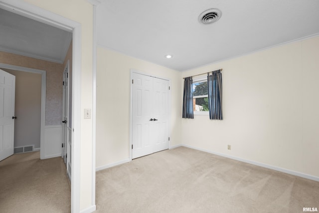 2303 Wynnewood Ct, Davenport, IA 52807 - unfurnished bedroom with light colored carpet, crown molding, and a closet