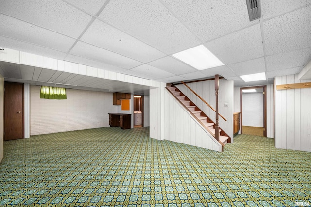 2303 Wynnewood Ct, Davenport, IA 52807 - finished below grade area with a drop ceiling, stairs, wood walls, and carpet