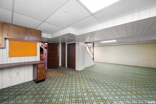 2303 Wynnewood Ct, Davenport, IA 52807 - finished below grade area featuring wooden walls, stairway, and a paneled ceiling