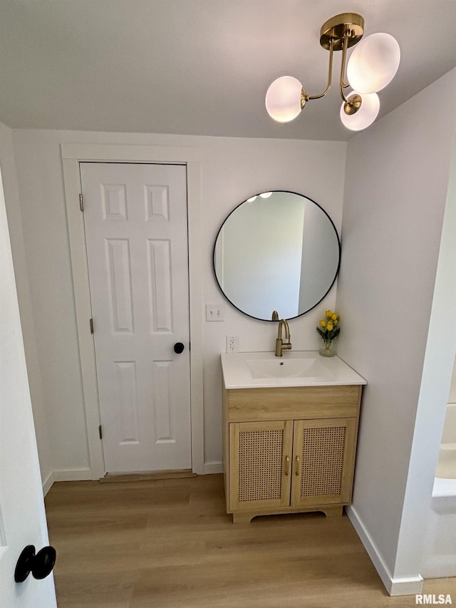 527 S Rotan St, Salem, IL 62881 - bathroom with wood finished floors, vanity, and a chandelier