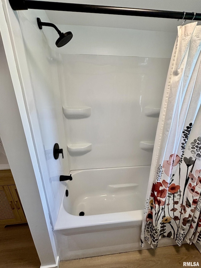 527 S Rotan St, Salem, IL 62881 - bathroom featuring shower / bath combo with shower curtain and wood finished floors