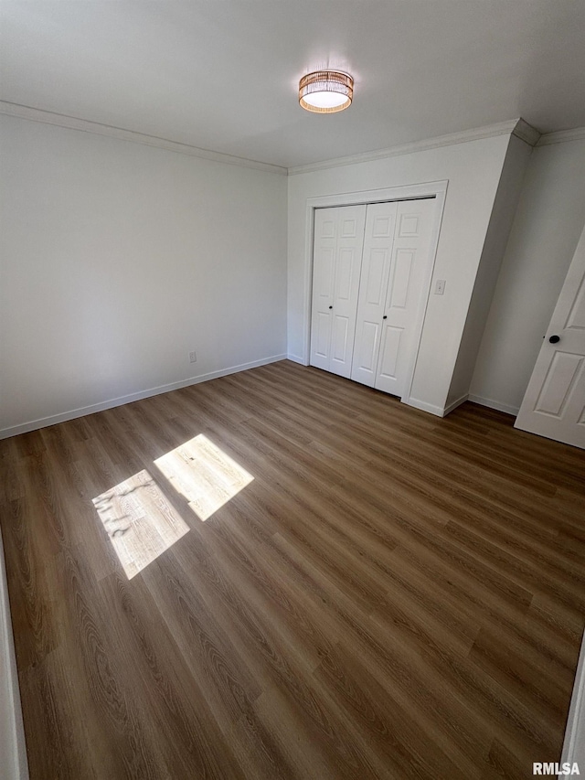 527 S Rotan St, Salem, IL 62881 - unfurnished bedroom featuring ornamental molding, dark wood-type flooring, and a closet