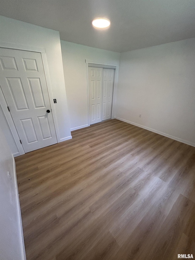 527 S Rotan St, Salem, IL 62881 - unfurnished bedroom with a closet and wood finished floors