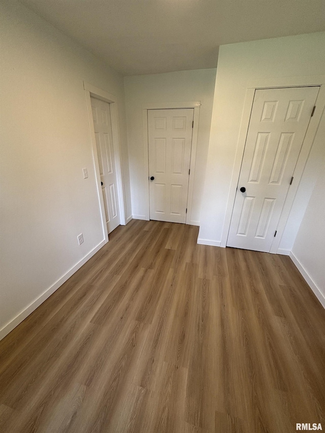 527 S Rotan St, Salem, IL 62881 - unfurnished bedroom with baseboards and dark wood-type flooring