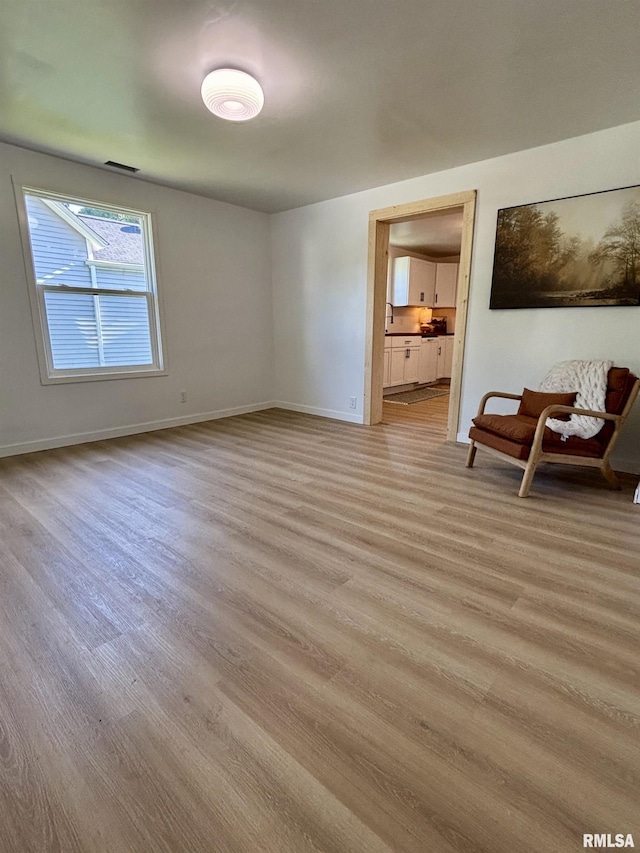 527 S Rotan St, Salem, IL 62881 - unfurnished living room with light wood-style floors