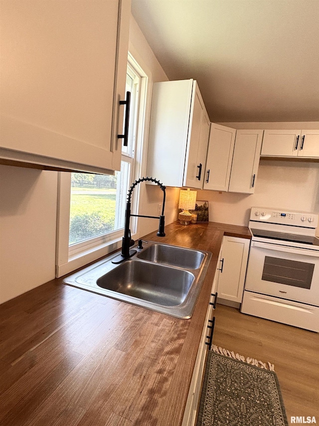 527 S Rotan St, Salem, IL 62881 - kitchen with electric range, wood finished floors, and white cabinets