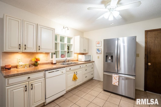 206 Patricia Ln, West Frankfort, IL 62896 - kitchen featuring white appliances, light tile patterned floors, tasteful backsplash, ceiling fan, and a textured ceiling