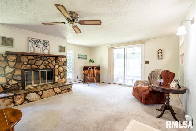 206 Patricia Ln, West Frankfort, IL 62896 - carpeted living room with ceiling fan, a textured ceiling, and a fireplace