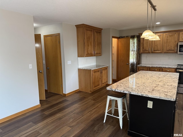 124 Riverview Heights Dr, Le Claire, IA 52753 - kitchen featuring dark wood finished floors, decorative backsplash, and brown cabinets