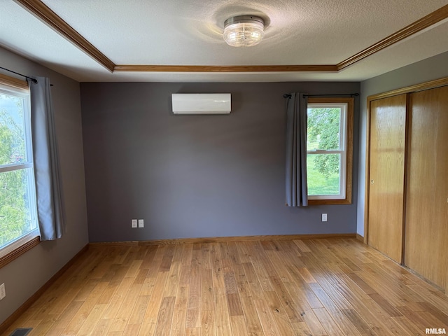 124 Riverview Heights Dr, Le Claire, IA 52753 - unfurnished room featuring light wood-style flooring, healthy amount of natural light, and a textured ceiling